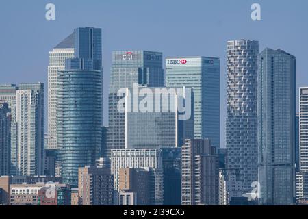 Die Menschenmassen genießen den Blick vom Hügel im Greenwich Park auf das National Maritime Museum und Canary Wharf und die Docklands Stockfoto