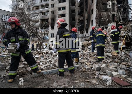 Borodyanka, Kiew, Ukraine. 6. April 2022. Feuerwehrleute beim Entfernen von Ziegeln gesehen. Der Rückzug der Russen aus der Pendlerstadt Borodyanka, nordwestlich von Kiew, hat offensichtliche Anzeichen von Zerstörungen von Zivilgebäuden hinterlassen und Berichten zufolge lagen 200 Menschen unter den Trümmern. Die Feuerwehrleute begannen, die Trümmer in der Stadt zu säubern und arbeiteten an teilweise eingestürzten Gebäuden. (Bild: © Valeria Ferraro/ZUMA Press Wire) Stockfoto