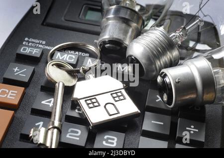 HAUS SCHLÜSSELRING MIT HAUSHALTSLAMPEN AUF RECHNER RE ENERGIE RECHNUNGEN STROM STEIGENDE KOSTEN ETC UK Stockfoto