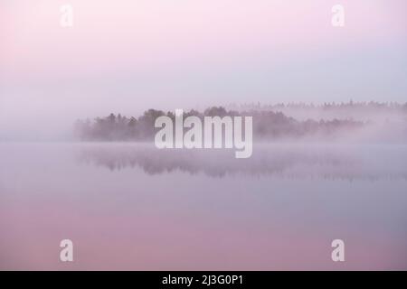 Morgennebel auf dem See in rosa und blauen Aquarellfarben Stockfoto