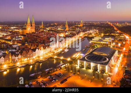 Luftaufnahme über die Trave und die Altstadt und die Kirchen der Hansestadt Lübeck bei Sonnenuntergang, Schleswig-Holstein, Deutschland Stockfoto