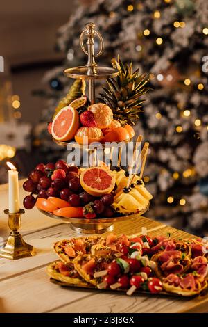 Essen auf dem servierten Festtisch. Obstteller, Käse, Canapes und Aufschnitt für das Buffet. Catering Stockfoto