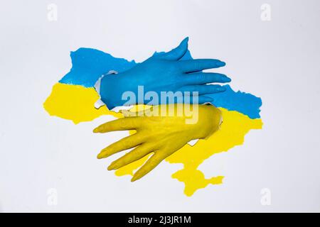 Frau Hände in Farbe mit Flagge der Ukraine gemalt. Zeichnung Karte der Ukraine in blau-gelber Farbe mit weiblichen Händen, die die UKRAINE retten. Stockfoto