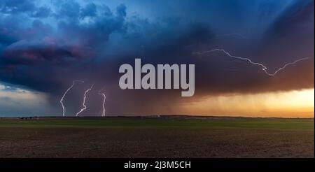 Blitzschläge von einem schwachen Luftmassengewitter bei Sonnenuntergang im Texas Panhandle; Texas, Vereinigte Staaten von Amerika Stockfoto