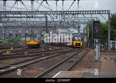 Northern Rail Klasse 142 Schrittzug und Siemens-Elektrozug der Klasse 333 in der Leeds-Bahnhofskehle am westlichen Ende des Bahnhofs.mit einem roten Signal Stockfoto