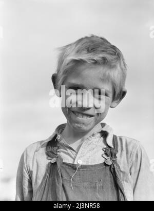 Sohn eines Baumwollpflückers, der in einem Hausbesetzerlager in der Nähe von Farmersville, Kalifornien, lebt. Stockfoto