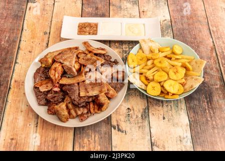 Bohneneintopf, Reis, Tomaten- und Zwiebelgerbung, gebratene oder geröstete reife Kochbananen, Avocado-Scheiben, gebratene Eier, wenn Sie es als ecuadorianischen chu zubereiten möchten Stockfoto