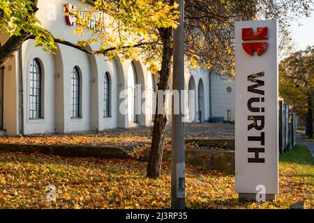 Logo der Würth-Gruppe vor einem Ladengebäude. Das Unternehmen ist bekannt für Montage- und Befestigungsmaterialien. Das Schild führt zum Einzelhandelsgeschäft. Stockfoto