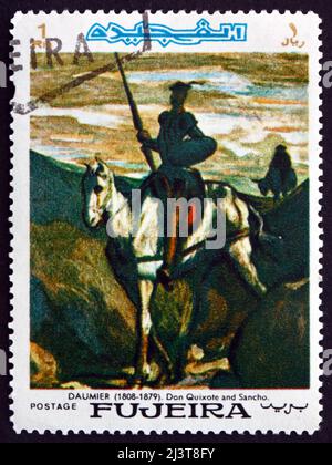FUJEIRA - UM 1967: Eine im Fujeira gedruckte Briefmarke zeigt Don Quixote und Sancho Panza, Gemälde von Honore Daumier, französischer Künstler und Maler, um Stockfoto