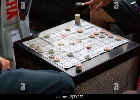 Zwei alte Chinesen spielen Xiangqi, auch bekannt als chinesisches Schach oder Elefantenschach. Stockfoto