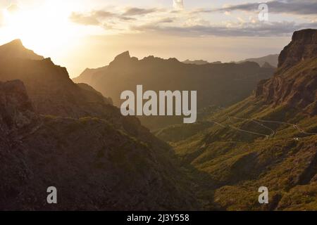 Sonnenuntergang hinter vulkanischen Gipfeln des Teno-Massivs, Masca-Tal im Nordwesten von Teneriffa Kanarische Inseln Spanien. Vom Mirador de Cherfe aus gesehen. Stockfoto