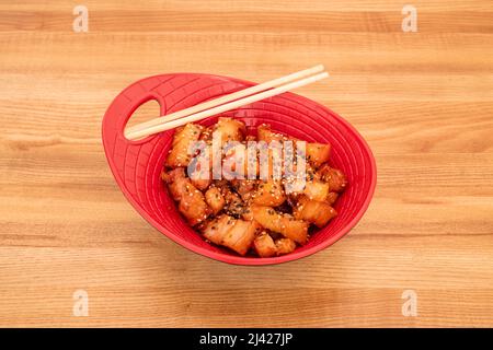 Schüssel mit Fusion Rezept aus gebratenem Speck mit Teriyaki-Sauce und Sesam und Mohnsamen Stockfoto