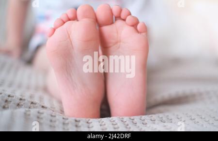 Nahaufnahme der Beine der Kinder mit den Füßen nach vorne Stockfoto