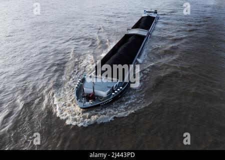 Köln, Deutschland. 11. April 2022. Ein mit Steinkohle beladenes Frachtschiff segelt auf dem Rhein. Angetrieben durch die hohen Energiepreise stieg die Inflation in Deutschland im März erstmals seit der Wiedervereinigung 1990 über die Marke von sieben Prozent. Nach vorläufigen Angaben des Statistischen Bundesamtes lagen die Verbraucherpreise um 7,3 Prozent über dem Vorjahresmonat. Details will die Wiesbadener Behörde am 12. April bekannt geben. Quelle: Rolf Vennenbernd/dpa/Alamy Live News Stockfoto