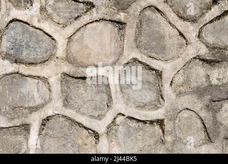 Textur einer Steinmauer. Alte Burg Stein Wand Textur Hintergrund. Stein Wand als Hintergrund oder Textur. Teil einer Mauer aus Stein, für den Hintergrund oder Text Stockfoto