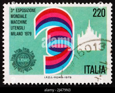 ITALIEN - UM 1979: Eine in Italien gedruckte Marke zeigt den Mailänder Dom, Ausstellungs-Emblem, 3. World Machine Tool Exhibition, Mailand, um 1979
