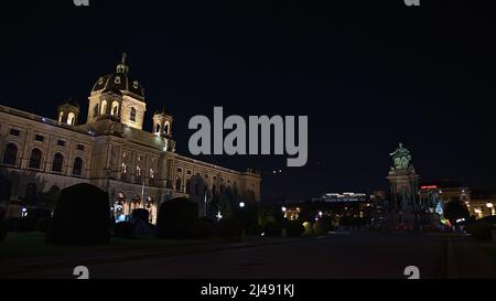 Nachtansicht des historischen Kunsthistorischen Museums in der Innenstadt von Wien, Österreich mit beleuchteter Fassade und Statue. Stockfoto