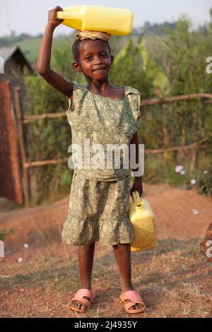 Kinder bringen Wasser aus einer lokalen Landpumpe, dem Dorf Cyayove, dem Mbazi-Sektor, Huye, Ruanda, Juli 2011 Stockfoto