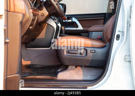 Auto im Fahrerplatz. Brauner Innenraum des modernen Prestige-Autos. Vordersitze mit Lenkrad-Armaturenbrett. Nach dem Waschen und Detaillieren. Stockfoto