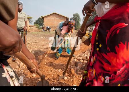 Umuganda monatlicher Gemeindedienst. Hier arbeiten sie am Bau von Klassenräumen für 12 Jahre Grundbildung an der Mwurire Groupe Scolare Schule, Mbazi Sektor, Huye District. Foto von Mike Goldwater Stockfoto