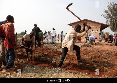 Umuganda monatlicher Gemeindedienst. Hier arbeiten sie am Bau von Klassenräumen für 12 Jahre Grundbildung an der Mwurire Groupe Scolare Schule, Mbazi Sektor, Huye District. Foto von Mike Goldwater Stockfoto