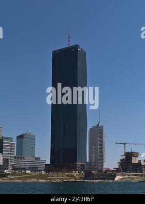 Blick auf den Wolkenkratzer DC Tower 1 (220 m) in der Donau City im Norden von Wien, Österreich, am Donauufer an sonnigen Frühlingstag. Stockfoto