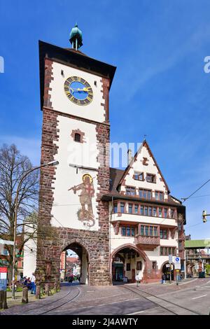 Freiburg, Deutschland - April 2022: Turm mit Tor namens Schwabentor, ein verbliebenes Stadttor der mittelalterlichen Verteidigungsmauer Stockfoto