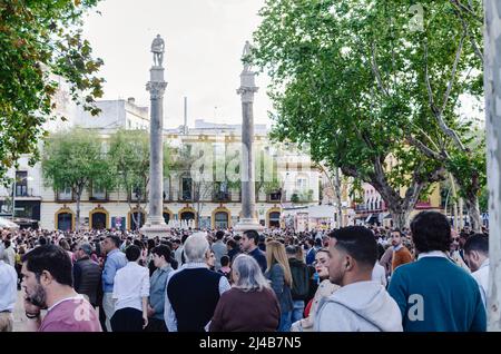 Sevilla, Spanien; 13. April 2022: Menschenmenge, die während der Karwoche auf eine Prozession wartet. Alameda Square. Stockfoto