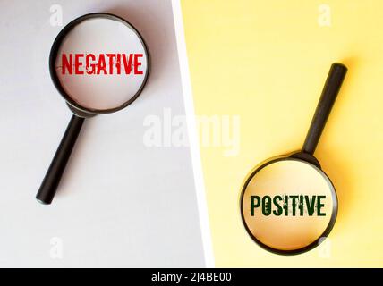 Lupe auf fehlendem Puzzle mit POSITIVEM NEGATIVEM Wort, Antonym-Konzept und selektivem Fokus. Stockfoto