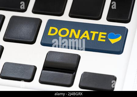 Tastaturtaste mit dem Wort Spenden und einem Herzen in den Farben der ukrainischen Flagge. Konzepte: Unterstützung und Solidarität mit Ukrainern, Hilfe zur Flucht Stockfoto