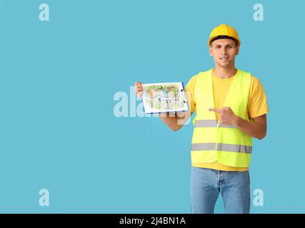 Junger männlicher Landschaftsdesigner mit neuem Projekt auf farbigem Hintergrund Stockfoto