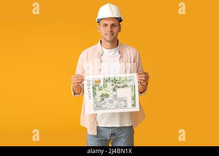 Junger männlicher Landschaftsdesigner mit neuem Projekt auf farbigem Hintergrund Stockfoto