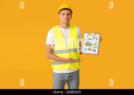 Junger männlicher Landschaftsdesigner mit neuem Projekt auf farbigem Hintergrund Stockfoto