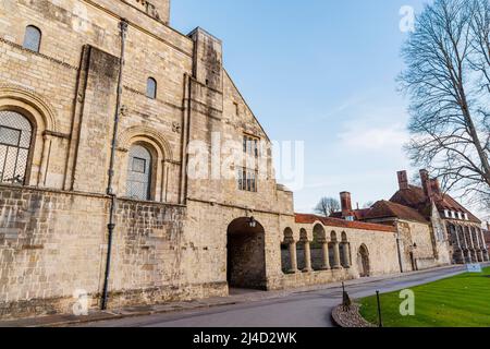 Das alte Kapitelhaus am Eingang des Dean Garnier Garden auf der Südseite der Winchester Cathedral von der Cathedral Close, Winchester, Hampshire aus gesehen Stockfoto