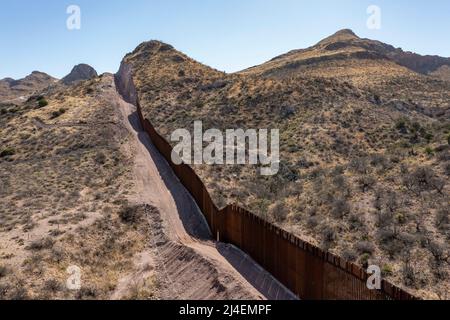 Douglas, Arizona - der Grenzzaun zwischen den USA und Mexiko endet abrupt im Guadalupe Canyon, wo Bauarbeiter einen Gasch in einen Berghang sprengten. Präsid Stockfoto