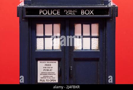 Polizeiruf-Box auf rotem Hintergrund isoliert. Tardis von Doctor Who. Nahaufnahme Stockfoto