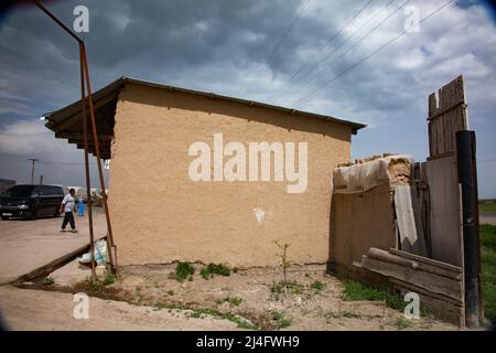 Südkasachstan - April 28,2012: Traditionelles asiatisches Haus im Dorf aus lehmziegeln gebaut. Ziegel aus Lehm und Stroh. Stockfoto