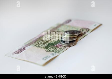 Russische Rubel-Banknoten und Münzen auf weißem Hintergrund Stockfoto