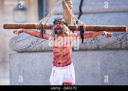 Trafalgar Square, London, Großbritannien. 15. April 2022. ‘Karfreitag an Ostern präsentierte die Besetzung von Wintershall die ‘Passion Jesu’, ein Stück, das die biblische Geschichte Christi durch die „Wunder“, das letzte Abendmahl, Und die Kreuzigung durch die Römer, bevor sie wieder auferstehen, und die Auferstehung, die alle den Trafalgar Square als Bühne für die kostenlose öffentliche Veranstaltung nutzen. Christus wird vom Schauspieler James Burke-Dunsmore dargestellt, der die Rolle seit vielen Jahren spielt Stockfoto