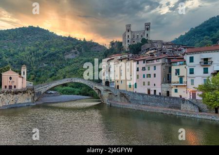 DOLCEACQUA, ITALIEN - CA. AUGUST 2020: Dolceacqua Panorama mit der antiken römischen Brücke aus Steinen und der Burg Stockfoto