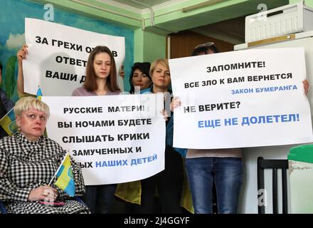 ODESA, UKRAINE - 15. APRIL 2022 - Frauen halten Plakate, als sie russische Mütter aufrufen, die russische Invasion in Odesa, Südukraine, zu stoppen. Stockfoto