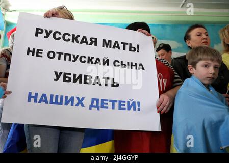 ODESA, UKRAINE - 15. APRIL 2022 - Eine Frau hält ein Plakat "Russische Mutter! Lass deinen Sohn nicht hierher kommen und unsere Kinder töten, wie Aktivisten auf Ru rufen Stockfoto