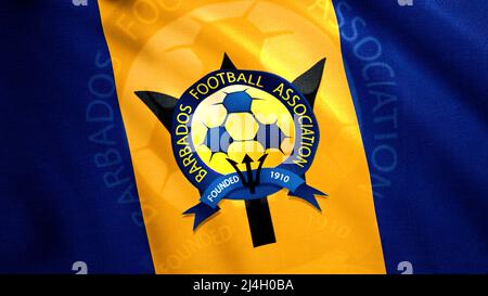 Flagge zu Ehren des Barbados Football Association. Bewegung. Leuchtend blauer und gelber Stoff mit einem Fußball in der Mitte. Nur für redaktionelle Zwecke verwenden. Stockfoto