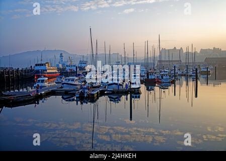 Großbritannien, North Yorkshire, Scarborough Harbour und Lighthouse mit Blick auf den West Pier und das Grand Hotel in the Distance. Stockfoto