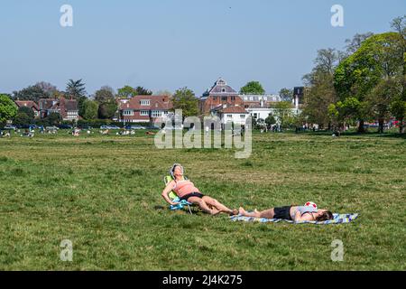 LONDON, GROSSBRITANNIEN. 16 April, 2022 . Zwei Frauen sonnen sich in der Frühlingssonne am Wimbledon Common im Südwesten Londons, nachdem am Karfreitag der heißeste Tag des Jahres verzeichnet wurde, wobei die Temperaturen über den osterfeiertag auf 23 grad celsius steigen dürften. Kredit: amer ghazzal/Alamy Live Nachrichten Stockfoto