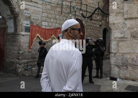 Jerusalem, Israel. 17. April 2022. Ein Palästinenser steht vor israelischen Sicherheitskräften an einem Kontrollpunkt inmitten von Zusammenstößen mit Palästinensern in der Altstadt von Jerusalem. Quelle: Ilia Yefimovich/dpa/Alamy Live News Stockfoto