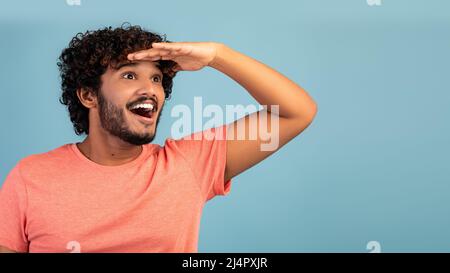 Aufgeregt hindu Kerl Blick auf den Kopierraum auf blau Stockfoto