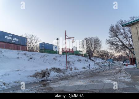 März 17 2022 - Winnipeg Manitba Canada - Lokomotive mit Containern über eine Brücke Stockfoto