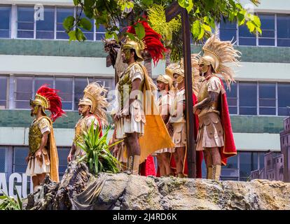 Menschen in Kostümen römischer Soldaten, die eine Statue von Jesus am Kreuz bei einer Karfreitagsprozession in San José, Costa Rica, umgaben. Stockfoto