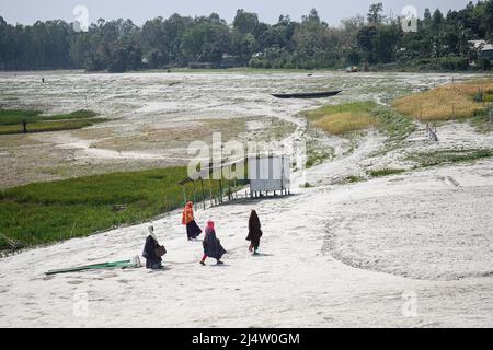 Bogra, Bangladesch. 20. März 2022. Fußgänger laufen am Ufer des Flusses Jamuna bei Sariakandi Upazila des Bezirks Bogra entlang. Kredit: SOPA Images Limited/Alamy Live Nachrichten Stockfoto